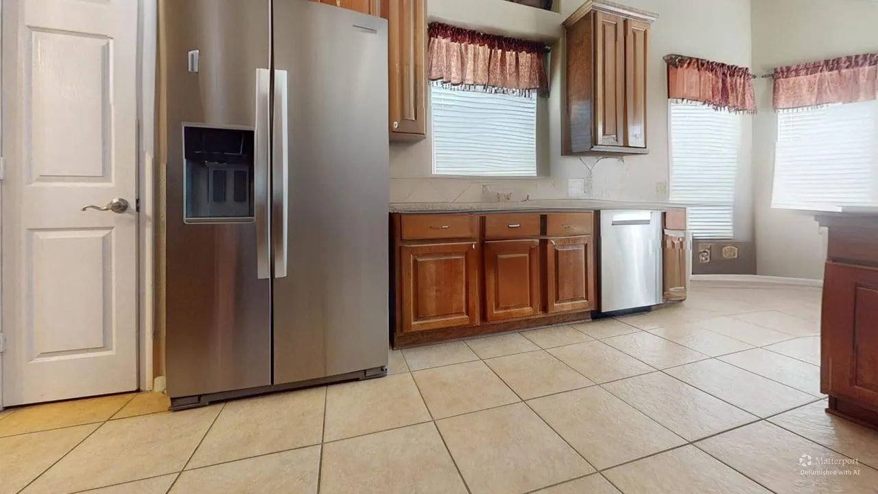 Kitchen cabinets, appliances and tile floor documented during an on-site walkthrough
